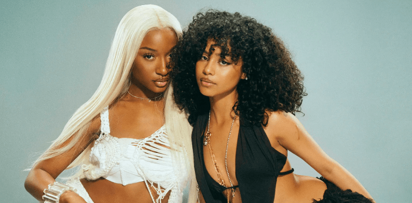 Ayra Starr and Tyla pose together in stylish outfits, showcasing their unique styles and vibrant personalities.