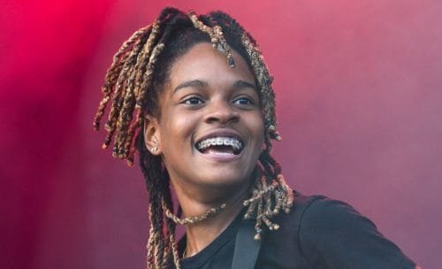 Smiling person with braided hair and braces