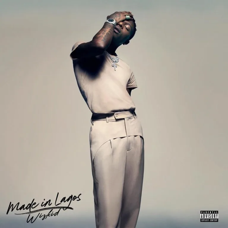 Artist posing in stylish outfit for album cover.